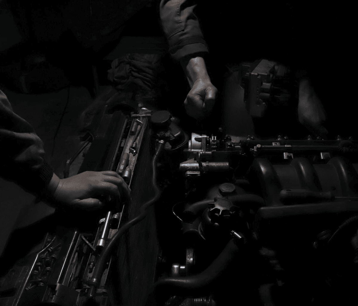 Auto mechanics working on an engine